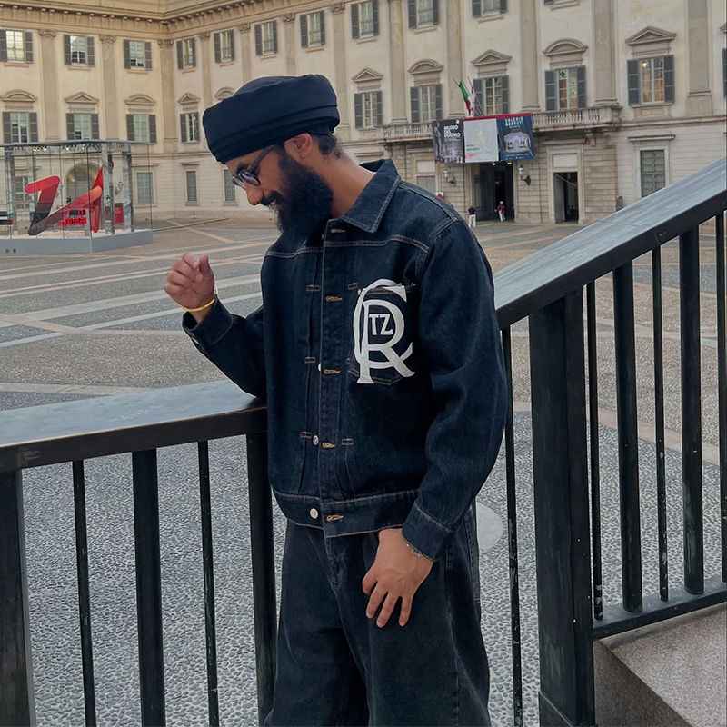 Corteiz Crest Chainstitch Denim Trucker worn with dark trousers